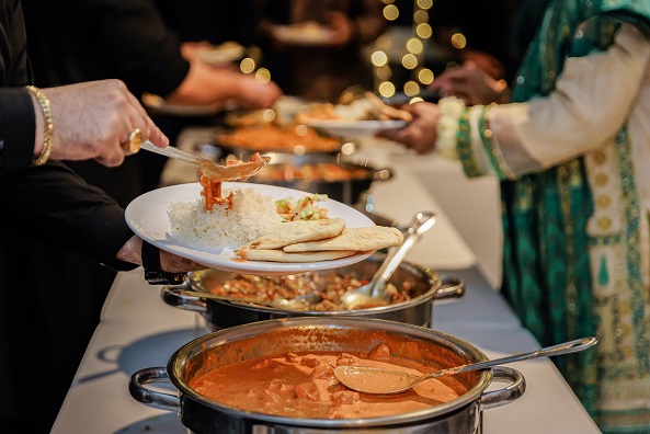 Guests being served from a catered buffet